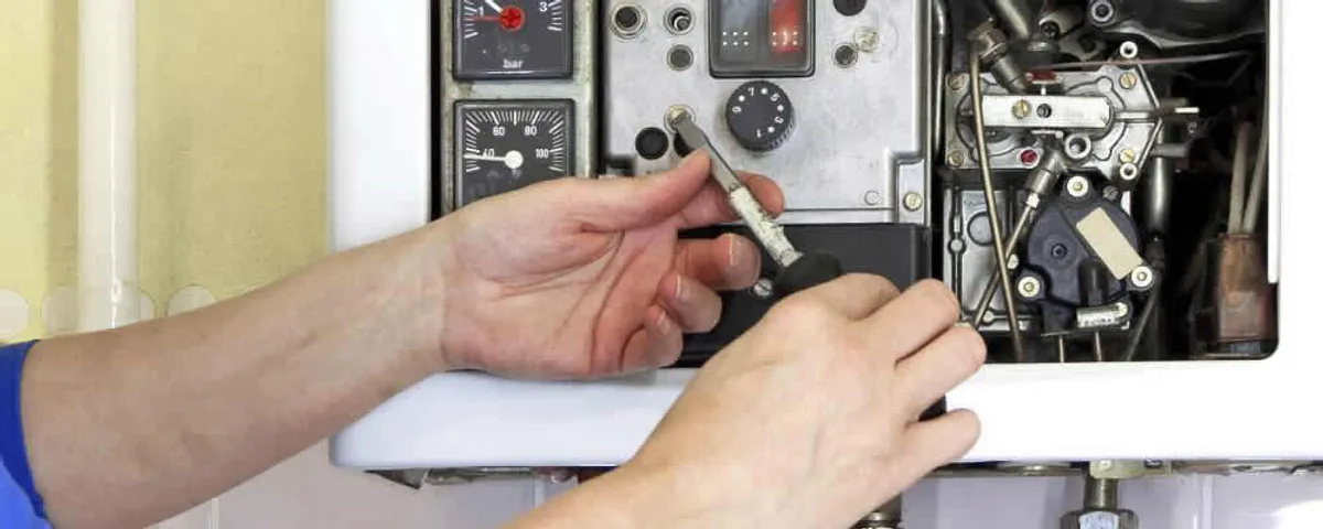 Heating repair technician adjusting boiler controls and components in Naperville, IL