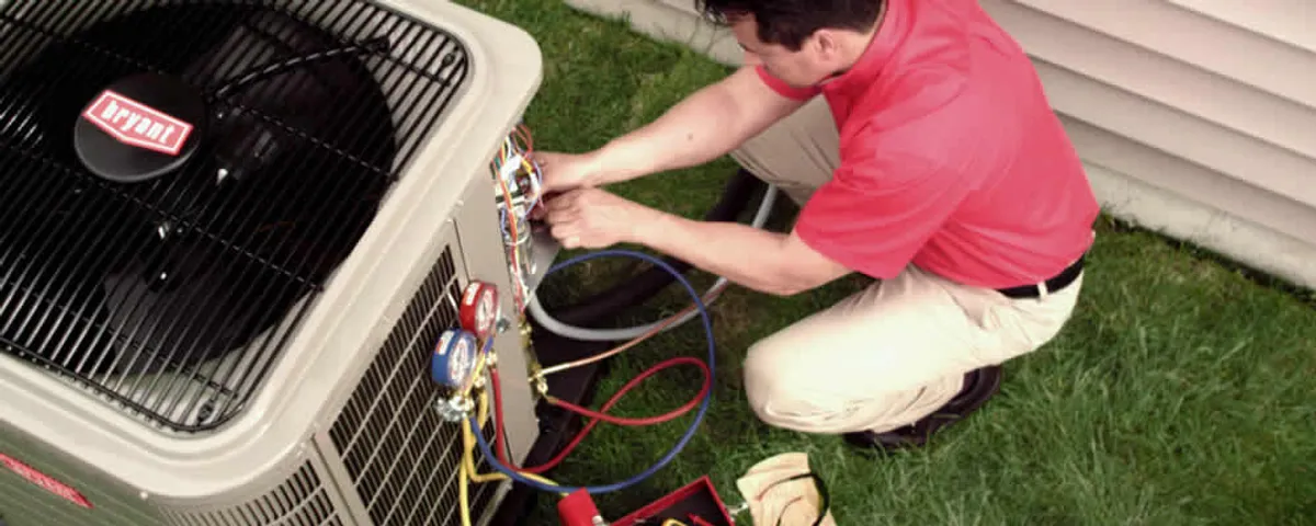 HVAC technician servicing an outdoor air conditioner unit in Naperville, IL