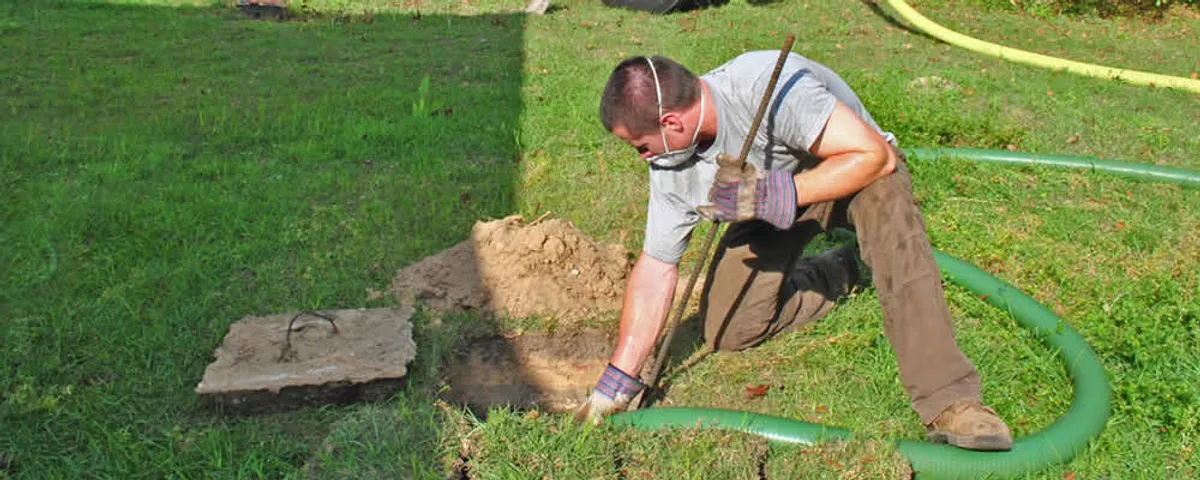 Septic pumping technician servicing a residential septic tank in Naperville, IL